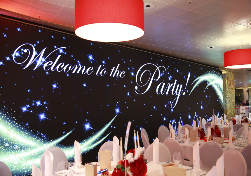 Festlich gedeckter Veranstaltungssaal mit LED-Wand zur Silvesterfeier im Kongresshotel Potsdam.