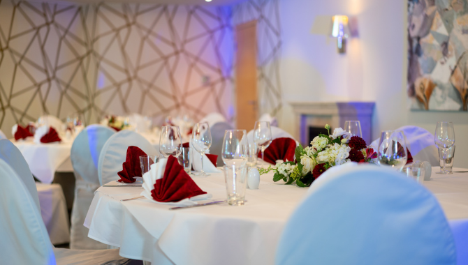 Hochzeitstafel mit Blumenschmuck und roten Servietten im Kongresshotel Potsdam.